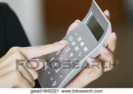 Close-up of a woman's hand using a calculator View Large Photo Image Stock Image - Close-up of a woman's hand using a calculator. Fotosearch