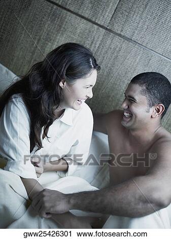 Close-up of a young couple laughing View Large Photo Image Stock Image - Close-up of a young couple laughing. Fotosearch