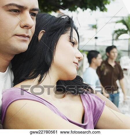Stock Image - Close-up of a young couple looking away. Fotosearch