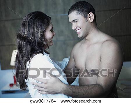 Close-up of a young couple smiling View Large Photo Image Stock Image - Close-up of a young couple smiling. Fotosearch