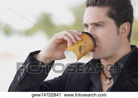 Close-up of a young man drinking coffee View Large Photo Image Stock Image - Close-up of a young man drinking coffee. Fotosearch