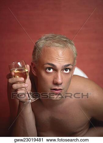 Close-up of a young man holding a glass of wine View Large Photo Image Stock Image - Close-up of a young man holding a glass of wine. Fotosearch