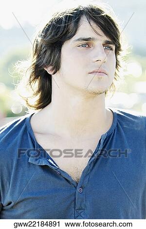 Close-up of a young man leaning against a railing View Large Photo Image Stock Image - Close-up of a young man leaning against a railing. Fotosearch
