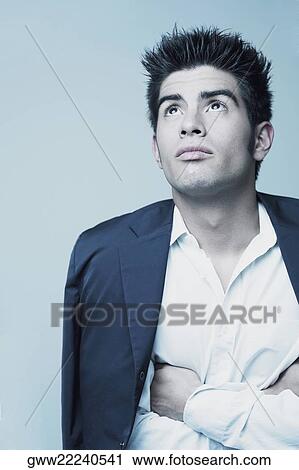 Close-up of a young man looking up View Large Photo Image Stock Image - Close-up of a young man looking up. Fotosearch