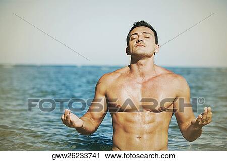 Close-up of a young man practicing yoga on the beach View Large Photo Image Stock Image - Close-up of a young man practicing yoga on the beach. Fotosearch