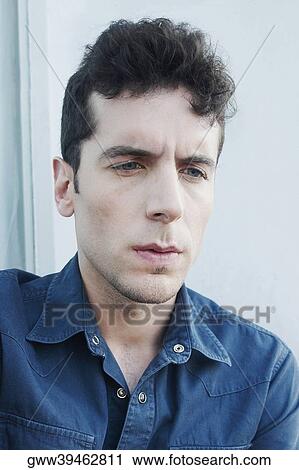 Close-up of a young man sitting with his hands on his knees View Large Photo Image Stock Image - Close-up of a young man sitting with his hands on his knees. Fotosearch