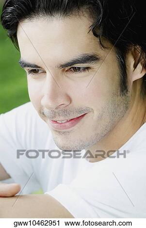Close-up of a young man smiling View Large Photo Image Stock Image - Close-up of a young man smiling. Fotosearch