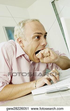 Close-up of a young man using a laptop View Large Photo Image Stock Image - Close-up of a young man using a laptop. Fotosearch