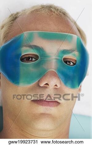 Close-up of a young man wearing an eye mask View Large Photo Image Stock Image - Close-up of a young man wearing an eye mask. Fotosearch