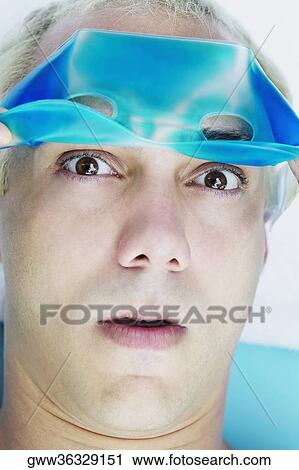 Close-up of a young man wearing an eye mask View Large Photo Image Stock Image - Close-up of a young man wearing an eye mask. Fotosearch