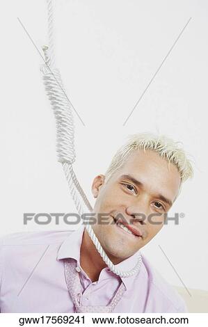 Stock Image - Close-up of a young man with a noose around his neck. Fotosearch