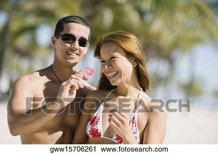 Close-up of a young woman and a mid adult man smiling together View Large Photo Image Stock Image - Close-up of a young woman and a mid adult man smiling together. Fotosearch