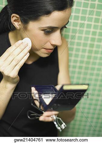 Close-up of a young woman applying face powder on her cheeks View Large Photo Image Stock Image - Close-up of a young woman applying face powder on her cheeks. Fotosearch