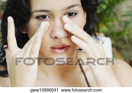 Close-up of a young woman applying suntan lotion View Large Photo Image Stock Image - Close-up of a young woman applying suntan lotion. Fotosearch