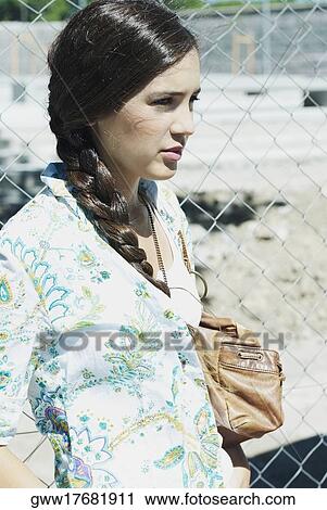 Close-up of a young woman carrying a hand bag View Large Photo Image Stock Image - Close-up of a young woman carrying a hand bag. Fotosearch