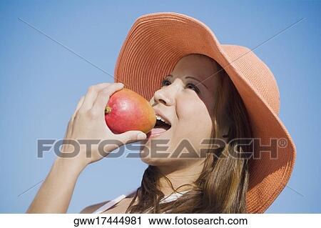 Close-up of a young woman eating an apple View Large Photo Image Stock Image - Close-up of a young woman eating an apple. Fotosearch