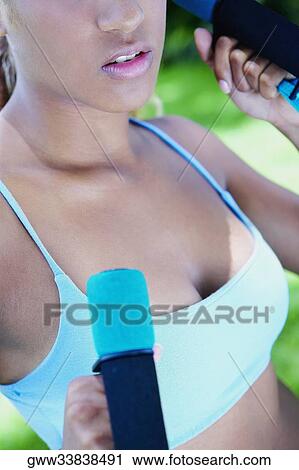Close-up of a young woman holding dumbbells View Large Photo Image Stock Image - Close-up of a young woman holding dumbbells. Fotosearch