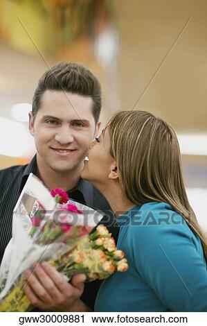 Close-up of a young woman kissing a young man View Large Photo Image Stock Image - Close-up of a young woman kissing a young man. Fotosearch