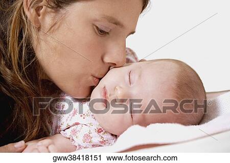 Close-up of a young woman kissing her daughter View Large Photo Image Stock Image - Close-up of a young woman kissing her daughter. Fotosearch