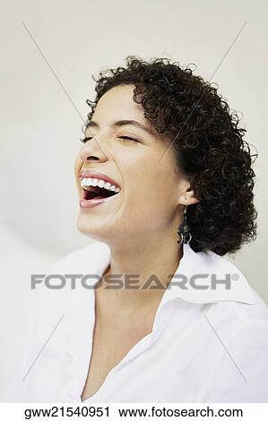 Stock Image - Close-up of a young woman laughing. Fotosearch