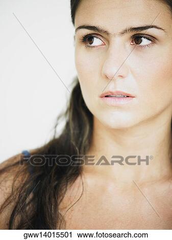 Close-up of a young woman looking away View Large Photo Image Stock Image - Close-up of a young woman looking away. Fotosearch
