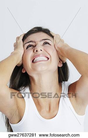 Close-up of a young woman suffering from a headache View Large Photo Image Stock Image - Close-up of a young woman suffering from a headache. Fotosearch