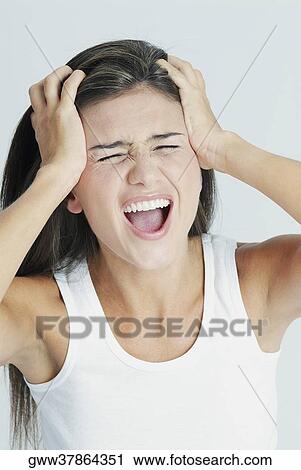 Close-up of a young woman suffering from a headache View Large Photo Image Stock Image - Close-up of a young woman suffering from a headache. Fotosearch