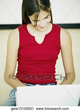 Stock Image - Close-up of a young woman using a laptop. Fotosearch