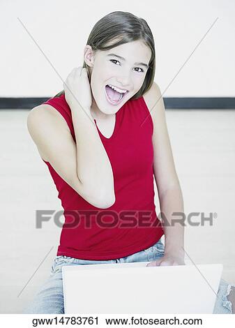 Stock Image - Close-up of a young woman using a laptop. Fotosearch