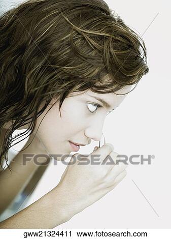 Close-up of a young woman using an eyelash curler View Large Photo Image Stock Image - Close-up of a young woman using an eyelash curler. Fotosearch