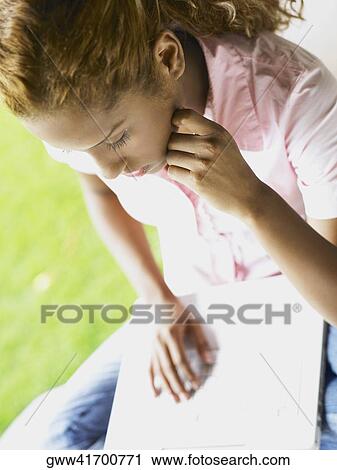 Close-up of a young woman working on a laptop View Large Photo Image Stock Image - Close-up of a young woman working on a laptop. Fotosearch