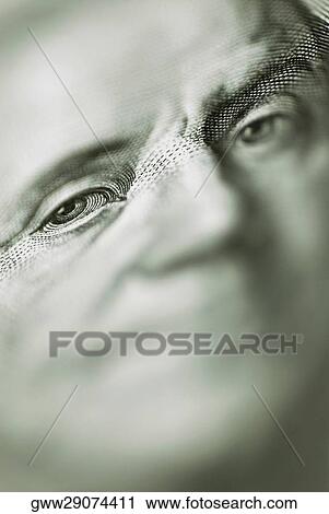 Stock Image - Close-up of Benjamin Franklin on a currency note. Fotosearch