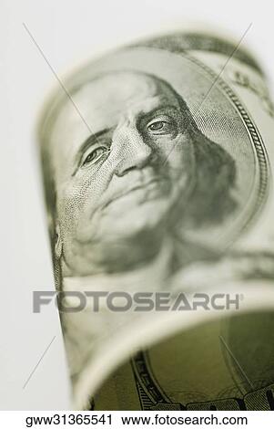 Stock Image - Close-up of Benjamin Franklin on a currency note. Fotosearch