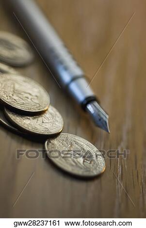 Close-up of coins with a fountain pen View Large Photo Image Stock Image - Close-up of coins with a fountain pen. Fotosearch