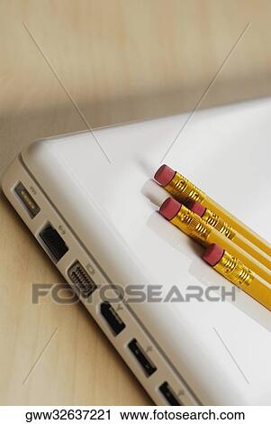 Close-up of four pencils on a laptop View Large Photo Image Stock Image - Close-up of four pencils on a laptop. Fotosearch
