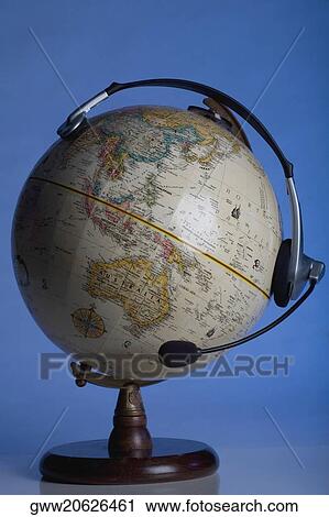 Stock Image - Close-up of headphones on a globe. Fotosearch