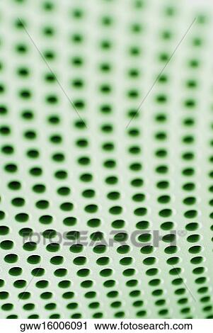 Stock Image - Close-up of holes on a metal surface. Fotosearch