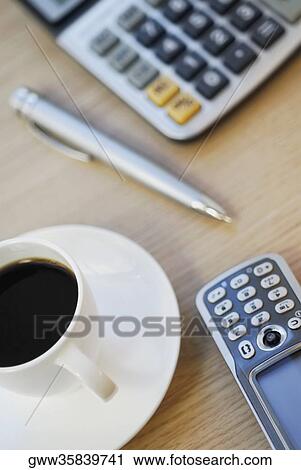Close-up of mobile phone with a pen and a calculator on the table View Large Photo Image Stock Image - Close-up of mobile phone with a pen and a calculator on the table. Fotosearch