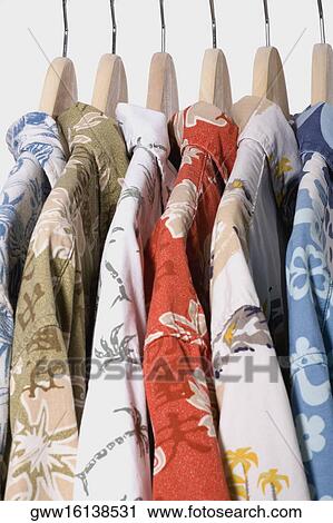 Close-up of multi-colored shirts on hangers View Large Photo Image Stock Image - Close-up of multi-colored shirts on hangers. Fotosearch