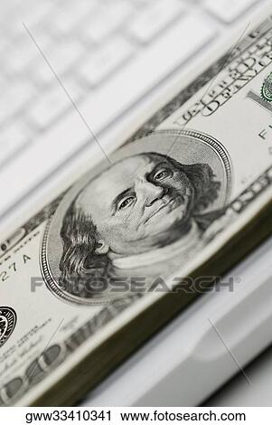 Close-up of one hundred dollar bill on a laptop View Large Photo Image Stock Image - Close-up of one hundred dollar bill on a laptop. Fotosearch