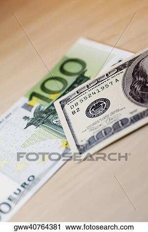 Close-up of one hundred Euro banknote and one hundred dollar bill View Large Photo Image Stock Image - Close-up of one hundred Euro banknote and one hundred dollar bill. Fotosearch