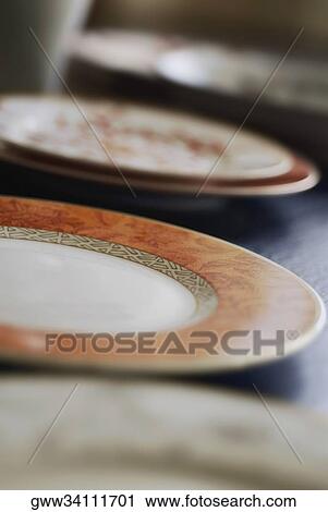 Close-up of plates on a table View Large Photo Image Stock Image - Close-up of plates on a table. Fotosearch