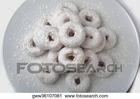 Close-up of powdered doughnuts in a plate View Large Photo Image Stock Image - Close-up of powdered doughnuts in a plate. Fotosearch