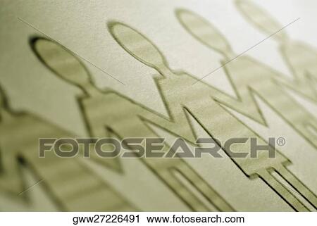 Stock Image - Close-up of the outline of paper chain dolls. Fotosearch