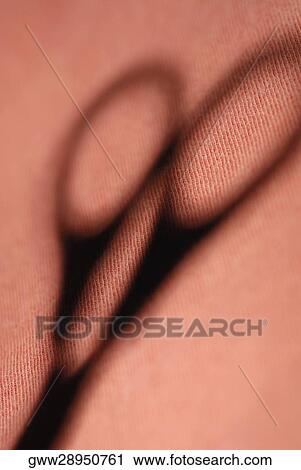 Close-up of the shadow of a pair of scissors View Large Photo Image Stock Image - Close-up of the shadow of a pair of scissors. Fotosearch