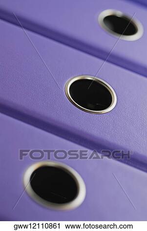 Stock Image - Close-up of three ring binders. Fotosearch