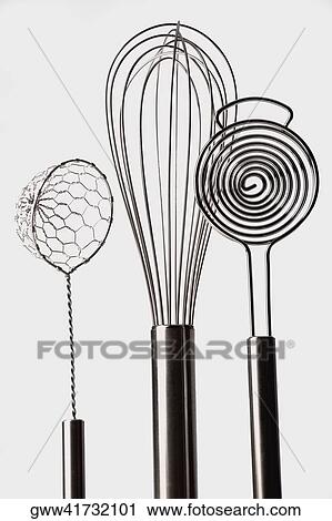 Stock Image - Close-up of three wire whisks. Fotosearch
