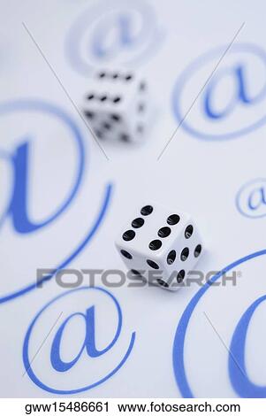 Close-up of two dices on a sheet of paper with At symbols View Large Photo Image Stock Image - Close-up of two dices on a sheet of paper with At symbols. Fotosearch