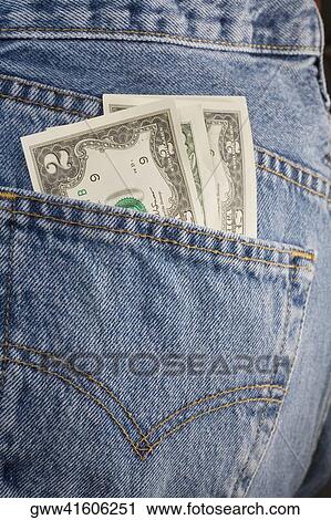 Close-up of two dollar bills in the pocket of a pair of jeans View Large Photo Image Stock Image - Close-up of two dollar bills in the pocket of a pair of jeans. Fotosearch