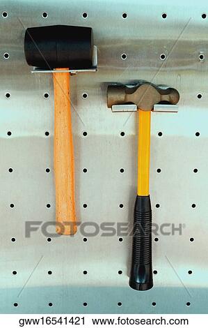 Close-up of two hammers hanging from hooks View Large Photo Image Stock Image - Close-up of two hammers hanging from hooks. Fotosearch